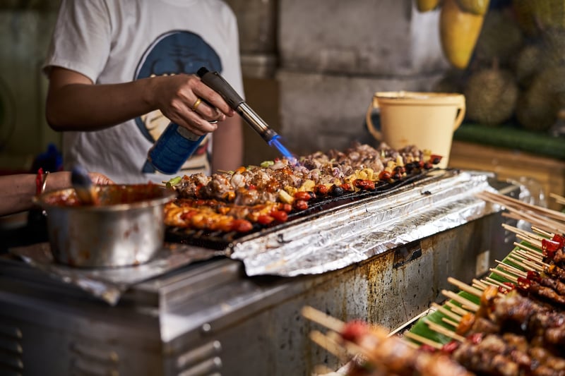 A local blowtocuching his slow food on a grill