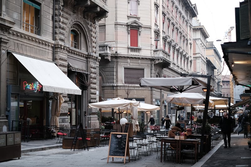 Beautiful architectural laneway with restaurants in Bologna, culinary capital of Italy