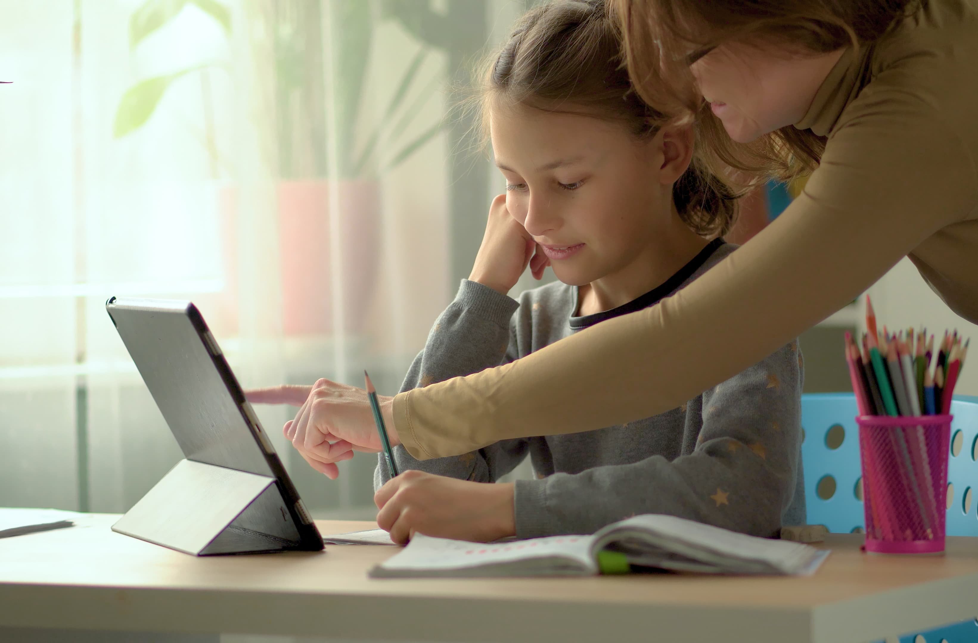 A mother home-schooling her young daughter