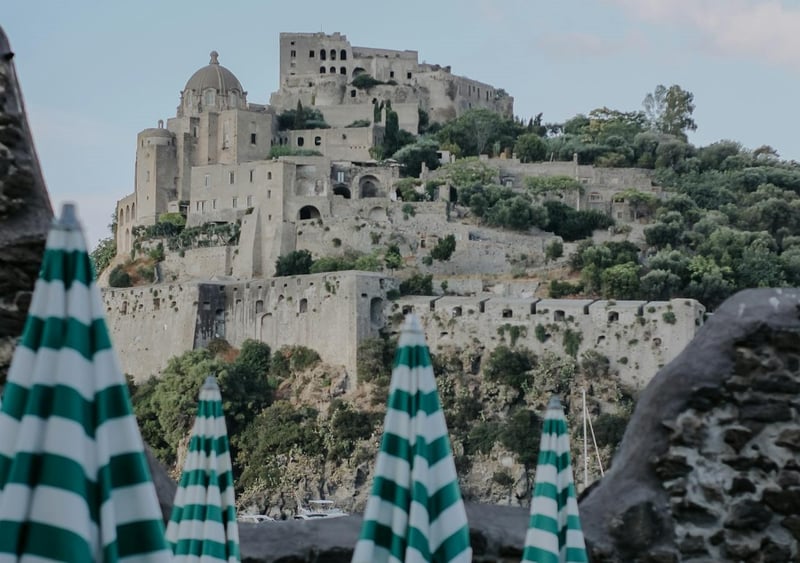 Italian castle hotel on a hilltop overlooking a beach in Naples