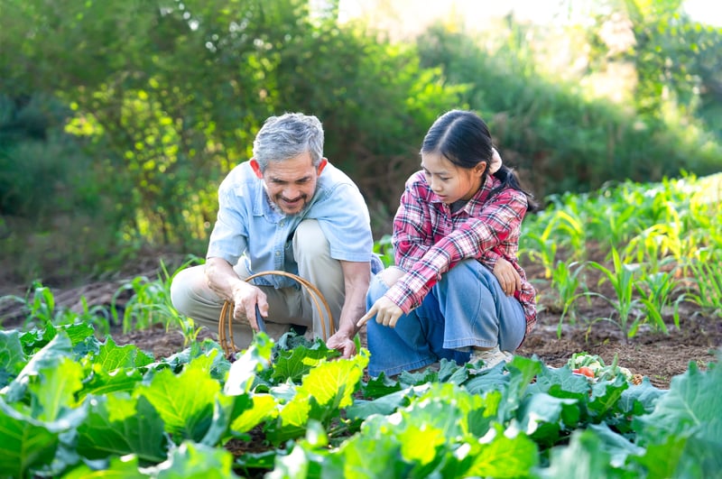 Grandfather and grandchild gardening as their purpose in life