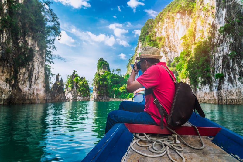 Tourist taking photo while Slow traveling on a boat in Coron in the Philippines