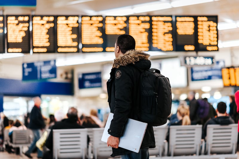 Solo traveler checking flight times and boarding gate