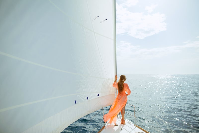 Woman in sarong yachting white sails luxury travel