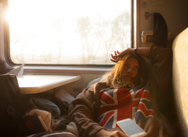 Young Thai girl solo traveler bored on a train